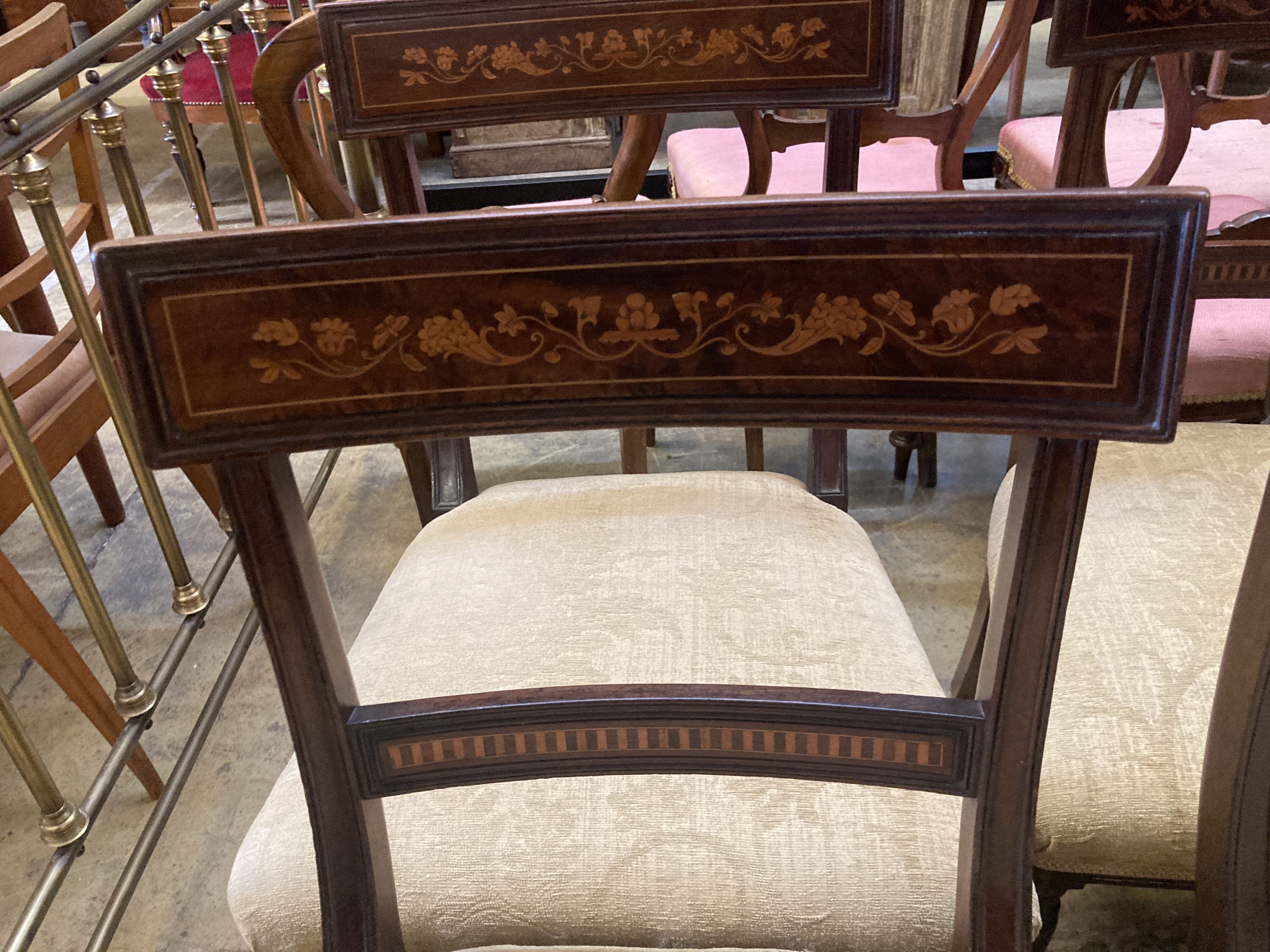 A set of six 19th century Dutch marquetry inlaid mahogany dining chairs